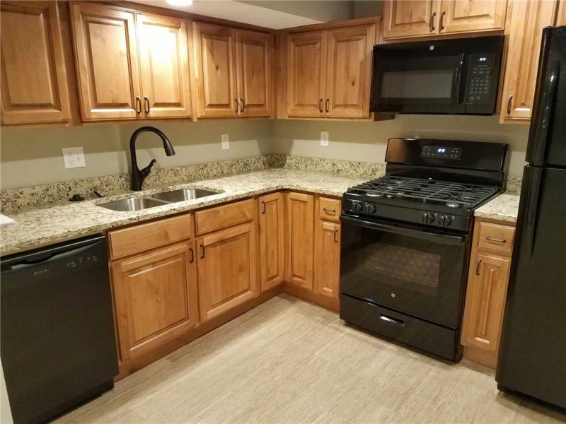 Updated kitchen with wood cabinets, granite countertops, and new appliances in Heber City studio apartment listing